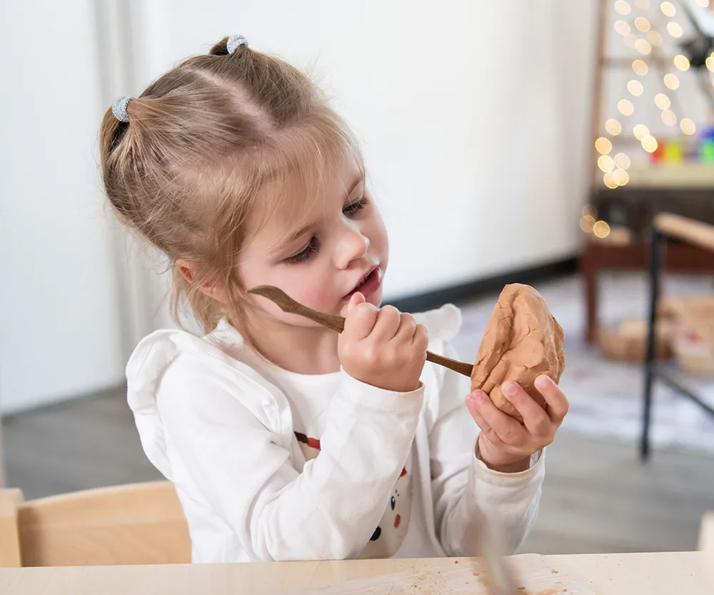 Child learning with natural materials in a Beyond Early Learning centre.