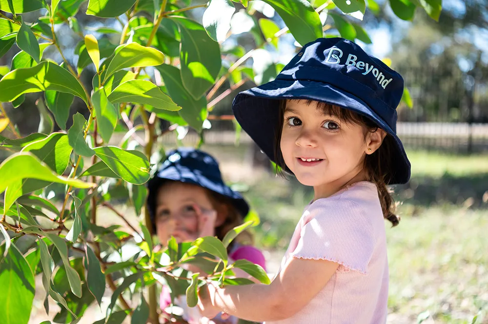 Happy children in a caring natural environment designed for wellbeing.